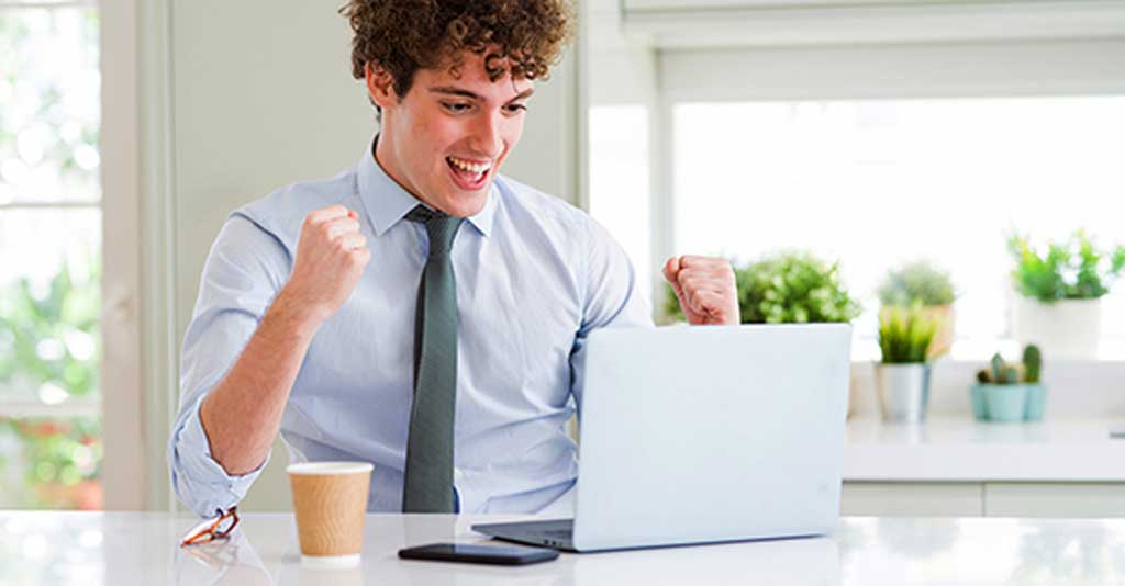 Young business man working with computer laptop at the office screaming proud and celebrating victory and success very excited, cheering emotion